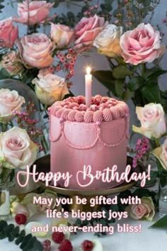 a pink birthday cake sitting on top of a table next to flowers and berries with the words happy birthday may you be gifted with life's biggest joys and never - ending bliss