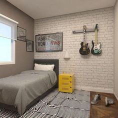 a bedroom with white brick walls and black and white rugs on the floor next to a bed