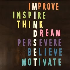 the words i improve inspire think dream believe motivvate on a wooden background with multicolored letters