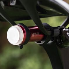 a close up view of the handlebars on a bicycle with red and white knobs