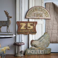 an assortment of antiques is displayed on a shelf in a room with white walls and wood floors