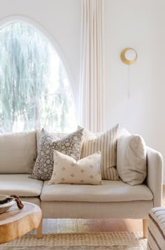 a living room filled with furniture and pillows