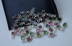 several pieces of silver and multicolored glass bead on a black book cover