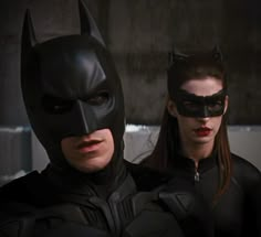 two people dressed up as batman and catwoman standing next to each other in the dark knight movie