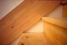 an unfinished wooden stair case in a house