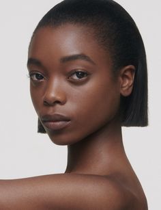 a woman with dark skin and black hair