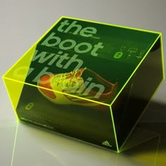 a green box with the words the book with fruit on it sitting on a table