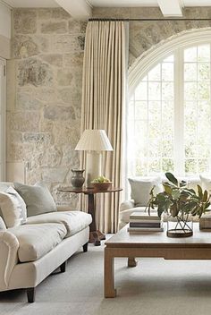 a living room with two couches and a coffee table in front of a large window