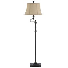 the floor lamp is black and has a beige fabric shade on it, with an iron base