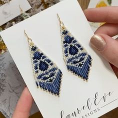 a pair of blue and white beaded earrings