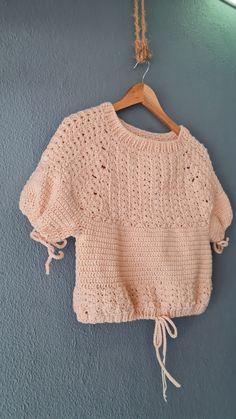 a pink sweater hanging on a wall