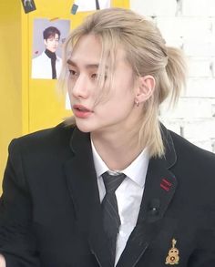 a person with blonde hair wearing a suit and tie