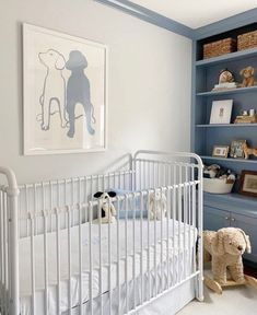 a baby's room with a white crib and bookshelves