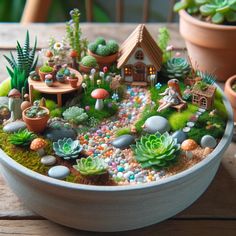 a bowl filled with plants and rocks on top of a table