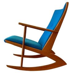 a wooden rocking chair with blue cushions