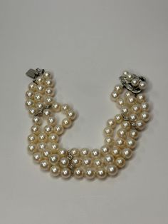 Vintage 14K White Gold Triple Strand Cultured Pearl and Diamond Bracelet. This bracelet is 8 inches in length, 7/8 inch in width, and weighs a total of 41.75 grams. The bracelet is tested 14k gold. Bracelet features 20 round cut diamonds. This pre-owned bracelet is in good condition and is ready to be worn! Bracelet is exactly as shown in photos. Willing to answer any questions and send more pictures if requested, please feel free to ask! Please come check out other stunning unique jewelry pieces listed in our shop! www.etsy.com/shop/AmericanJewelry224 Pearl And Diamond Bracelet, Gold Armband, Wedding Jewelry Bracelets, Wedding Bracelet, Round Cut Diamond, Cultured Pearls, Arm Band, Diamond Bracelet, Round Cut