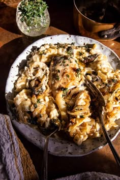 a white plate topped with pasta and mushrooms