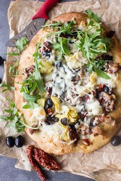 a pizza sitting on top of a piece of wax paper