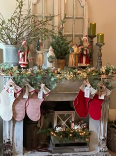 a mantel decorated with stockings and christmas decorations