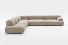 a large sectional couch sitting on top of a white floor