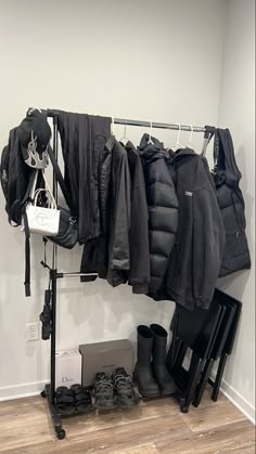 a coat rack filled with coats and shoes