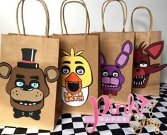 four paper bags with cartoon characters on them