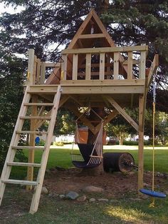 a wooden play structure with a ladder to the top and a treehouse above it