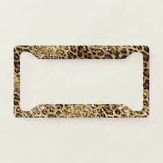 an animal print license plate holder on a white surface with gold glitters and black spots