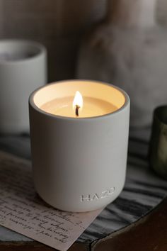 a white candle sitting on top of a wooden table