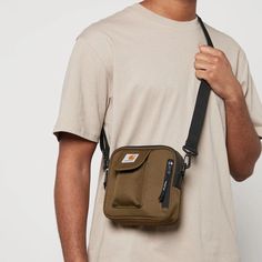 Carhartt Essentials bag.Olive shell.97% recycled polyester, 3% polyurethane.Adjustable strap, front pocket, logo plaque.Zip closure Carhartt Essentials Bag, Olive Shell, Cross Bags, Wip Bag, Shell Bag, Cream Bags, Gifts For Teen Boys, Tan Bag, Buy Bags