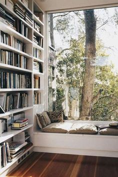 an image of a room with bookshelves and windows in arabic writing on the wall