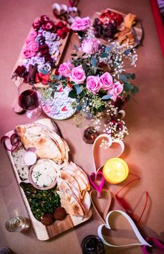 a table topped with lots of food and flowers