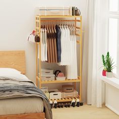 a bed room with a neatly made bed next to a wooden shelf filled with clothes