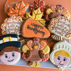 decorated cookies in the shape of thanksgiving turkeys and other holiday treats on a plate