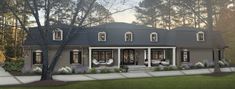 this is an artist's rendering of a house in the country style with large front porches