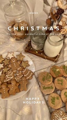 a table topped with lots of cookies next to a glass jar filled with snowflakes