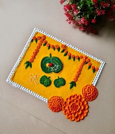 a close up of a rug on the ground with flowers and plants around it,