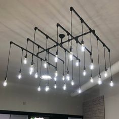 an industrial style chandelier with lights hanging from the ceiling