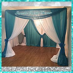 a blue and white stage set up with drapes, curtains, and lights on the floor