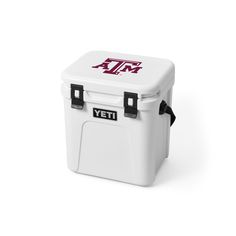 the yeti cooler is white and has maroon letters on it