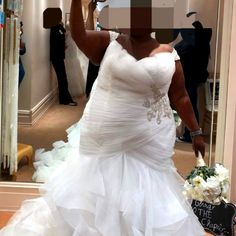 a woman in a wedding dress taking a selfie