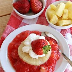 a plate with fruit and ice cream on it next to bowls of sliced pineapples