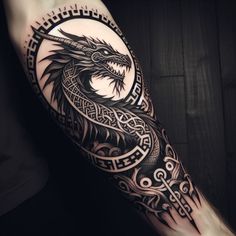 a black and white tattoo with a dragon on it's arm, in the shape of a circle