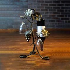 a wine glass holder with two wine glasses on top of it, sitting on a wooden table