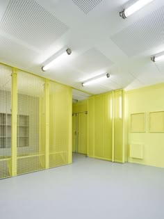 an empty room with yellow partitions on the walls