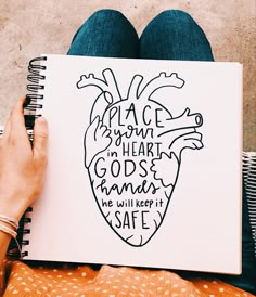 a person holding a notebook with a drawing of a heart on it and the words peace is your heart, god's human we will keep it safe