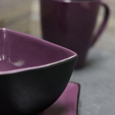 two purple bowls sitting on top of a table