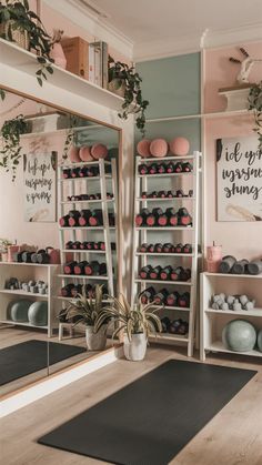 a room with yoga mats, plants and mirrors