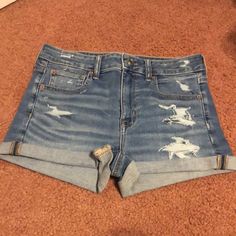 American Eagle Outfitters Distressed Shorts, Size 6, Super Stretch, Blue Color, With Zipper & Button Enclosure, Rolled Up At Bottom, Distressed In Front On Both Sides & On Back Pockets, 5 Pockets With American Eagle Logo On Back Of Shorts In Upper Left Hand Corner, Measuring Approximately 14” At Waist & 10-3/4” Long In Front, 12-1/8” Long In Back, Nwot American Eagle Logo, American Eagle Jean Shorts, Cuffed Denim Shorts, Shorts American Eagle, Ae Jeans, Ripped Denim Shorts, White Jean Shorts, Eagle Logo, American Eagle Shorts