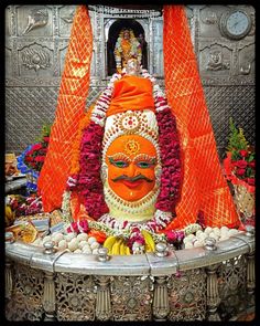 the statue is decorated with flowers and other decorations